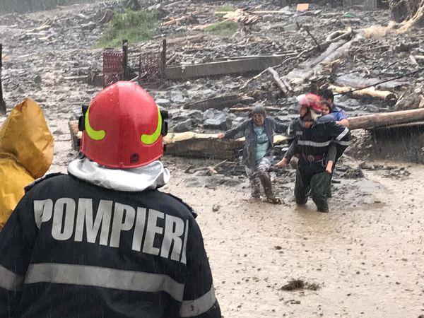 Oameni evacuaţi din cauza unei viituri. Un Drum Naţional este blocat de aluviuni