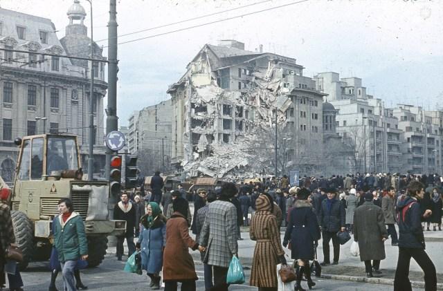 Se simte cutremur. E 4 martie 77. Mor peste 1.500 de oameni. Pe străzi se strâng dărâmăturile cu mătura. Ceaușescu privește și exclamă: "Demolați totul!"