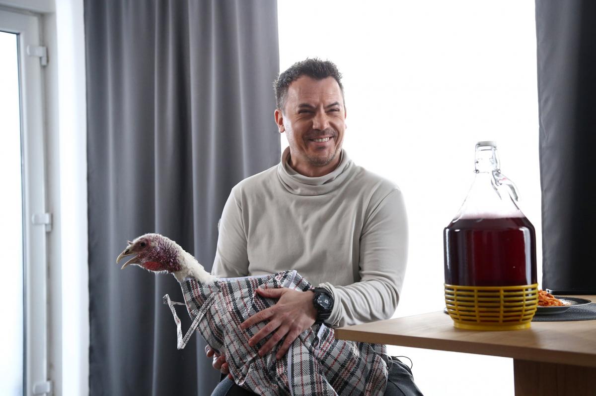 Răzvan Fodor poartă un pulover pe gât și citește ziarul