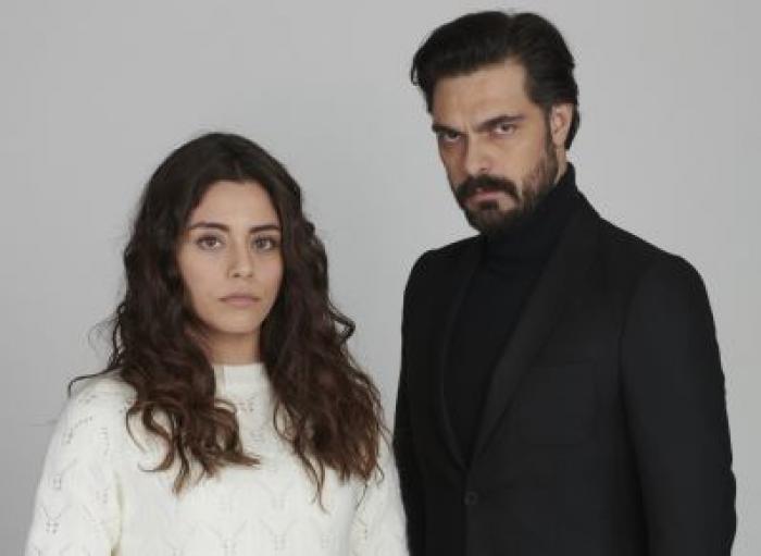 Halil Ibrahim Ceyhan poartă o maletă neagră și are un costum negru