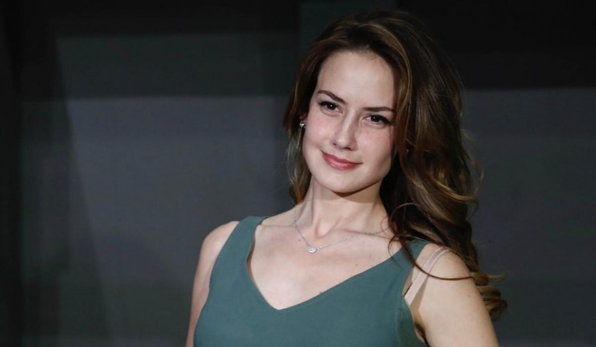 Altair Jarabo poartă un maiou verde închis și are părul desprins