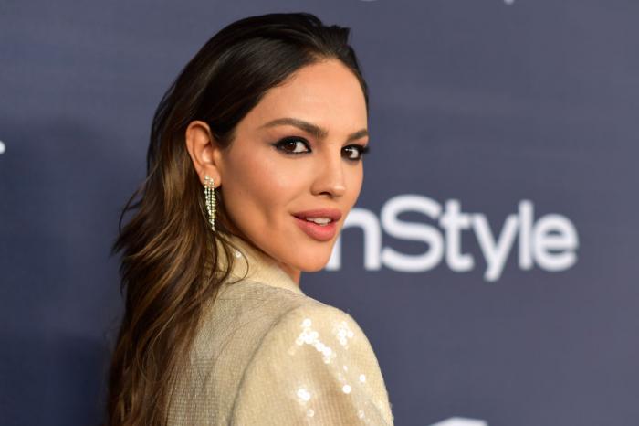 Eiza Gonzalez poartă un sacou strălucitor, deschis, bej și zâmbește