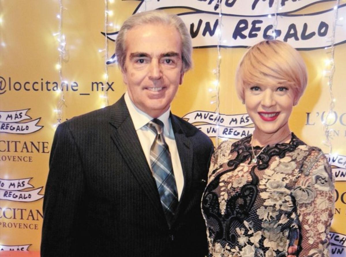 Lorenzo Lazo poartă o cămașă albă și un costum negru, iar Edith González poartă o rochie de gală