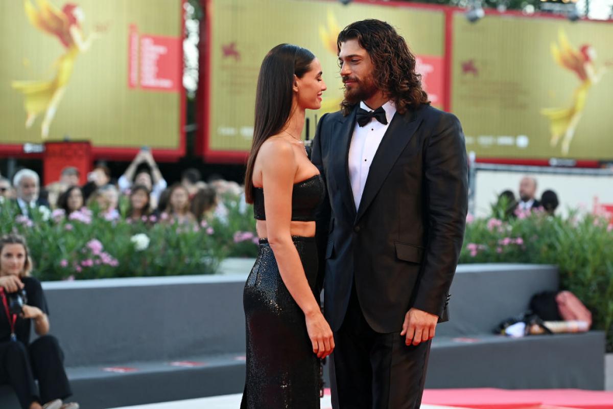 Can Yaman și Francesca Chillemi stau unul lângă celălalt pe covorul roșu și poartă vestimentații de gală