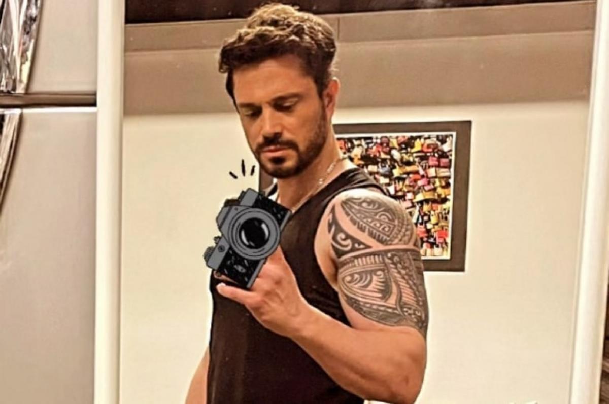 actor poartă maiou și un tatuaj