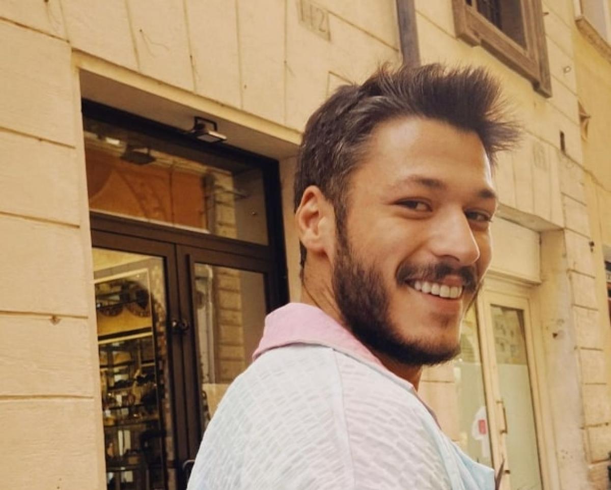 actor zâmbește și poartă o cămașă albă