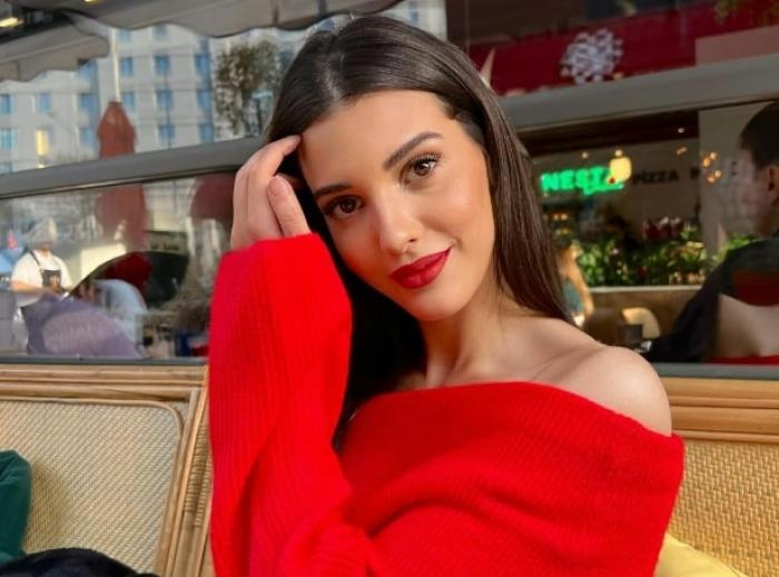 actriță poartă o bluză roșie și un ruj roșu