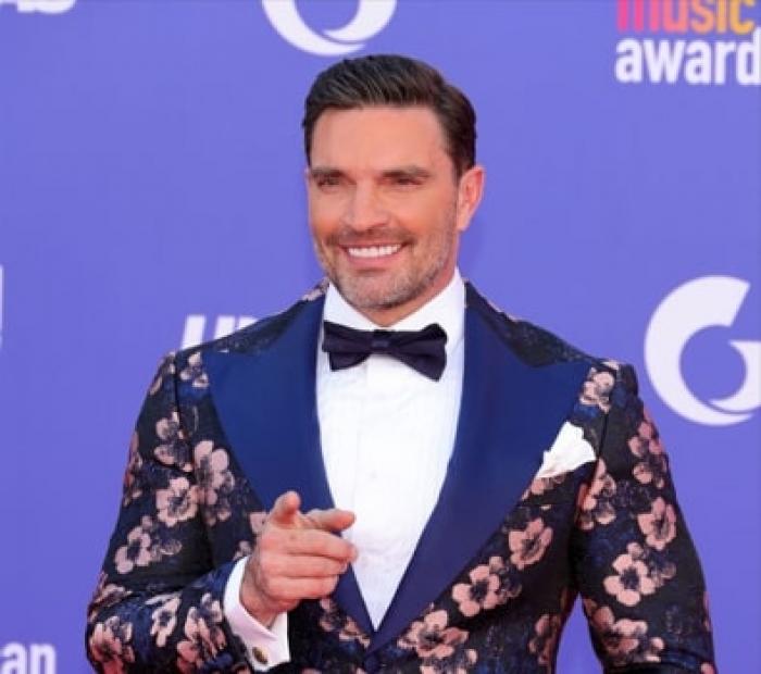 actor zâmbește pe covorul roșu