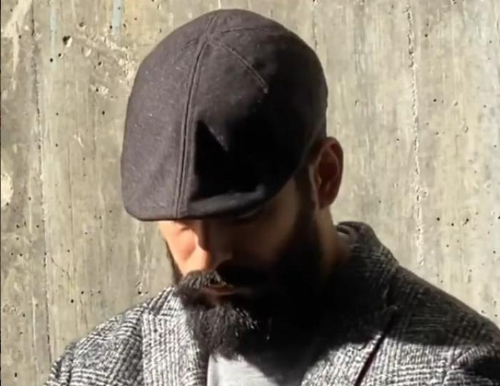 actor cu barbă care poartă o pălărie