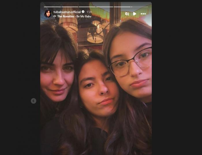 Tuba Buyukustun stă lângă gemenele sale